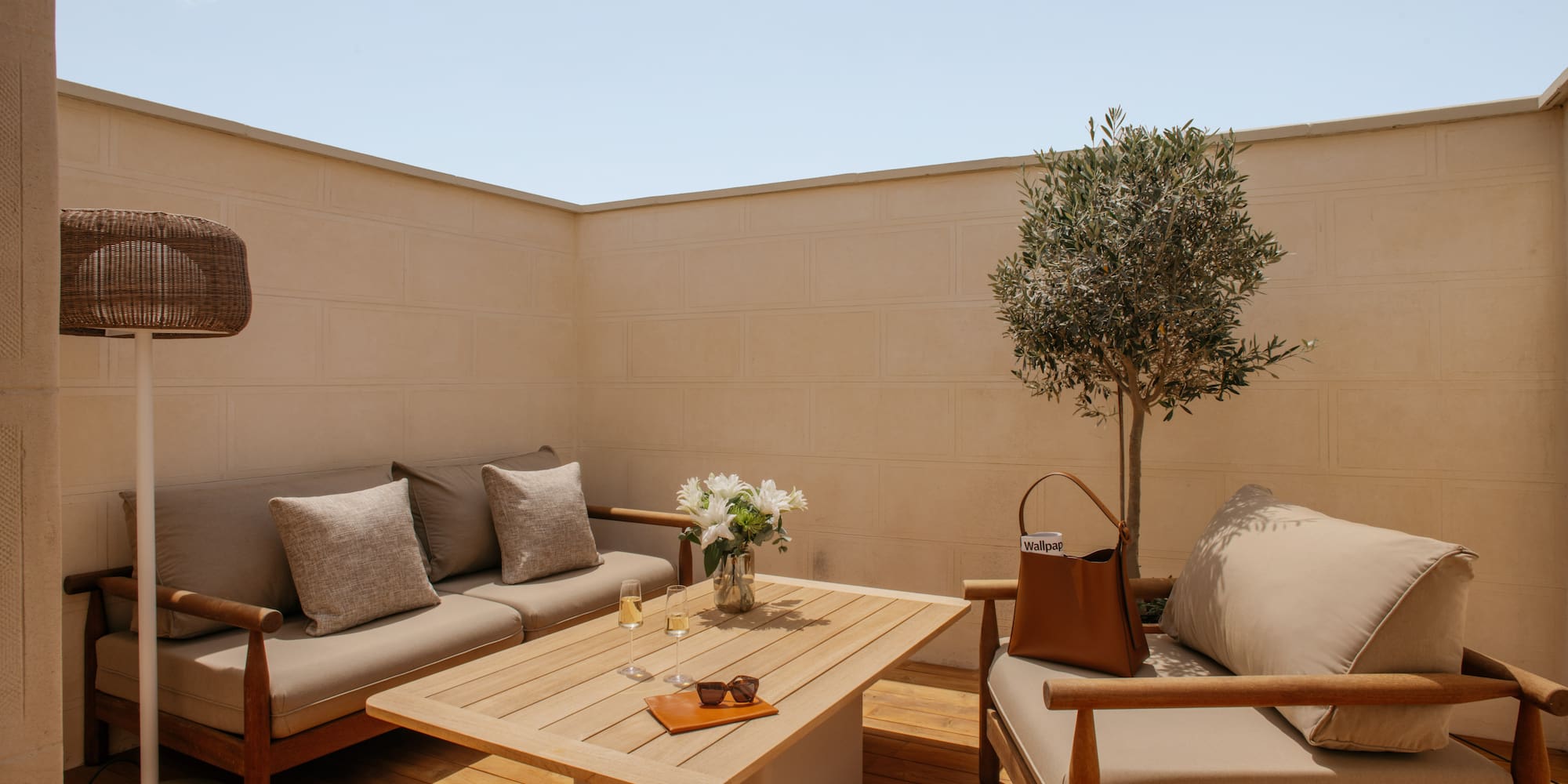 a patio furniture with a table and a tree