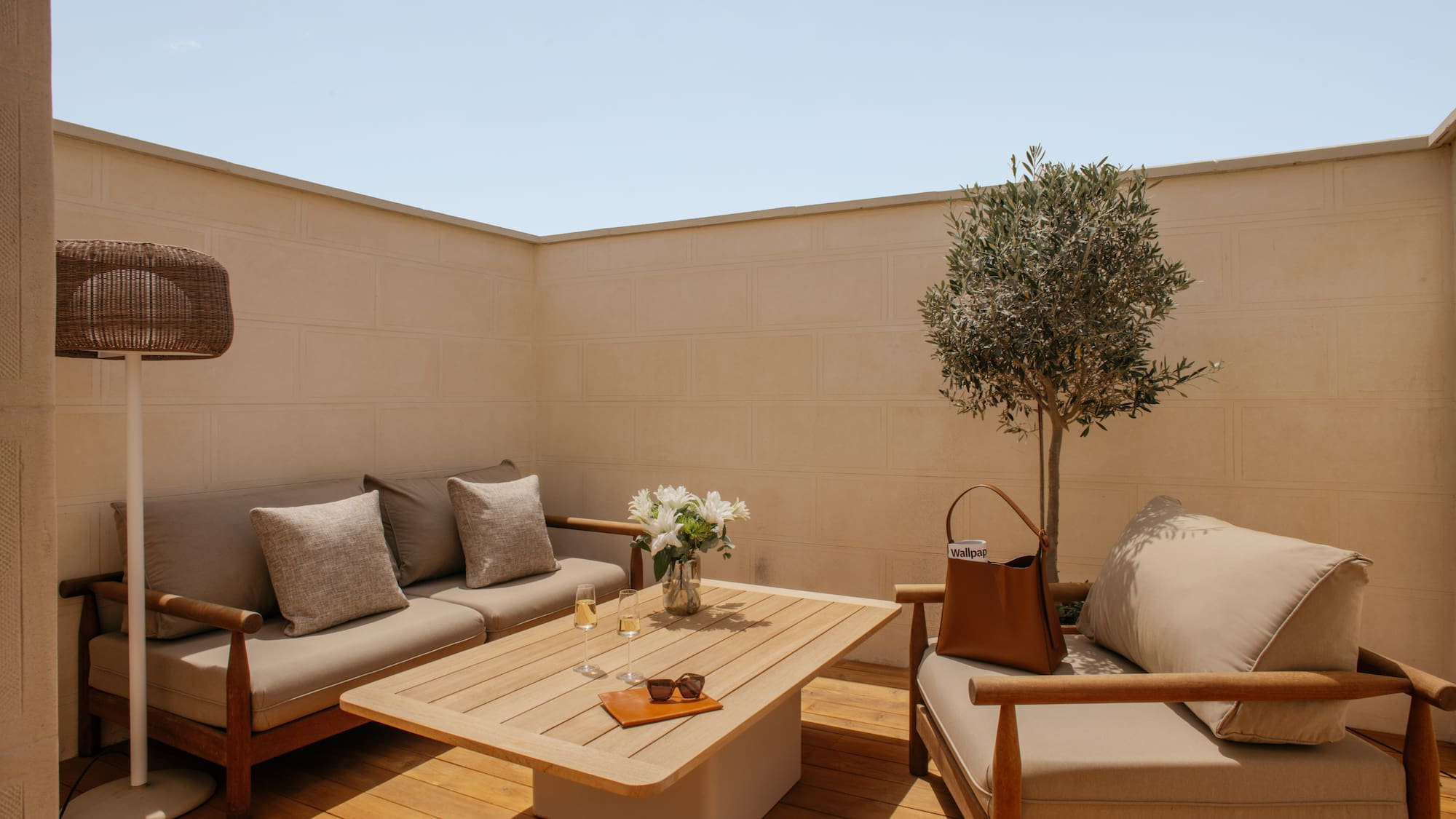 a patio furniture with a table and a tree