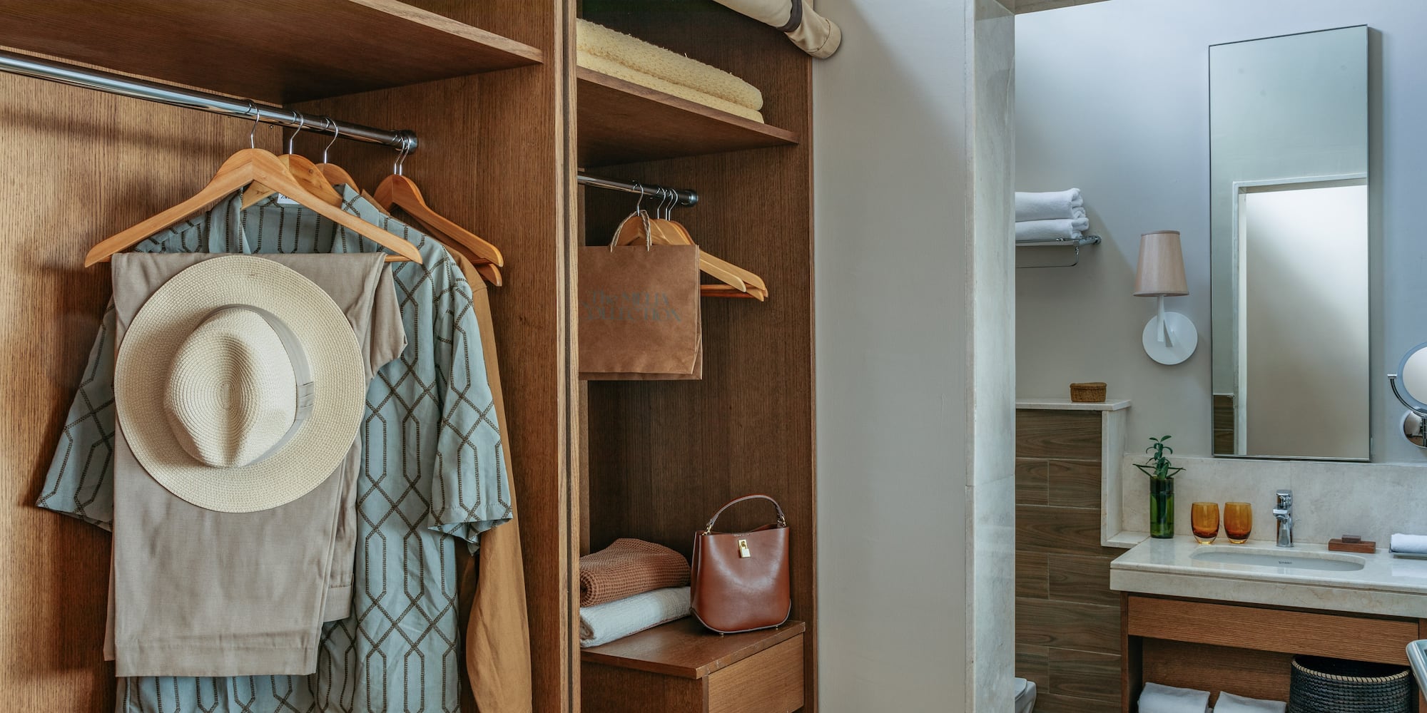 a closet with clothes on swingers and a towel