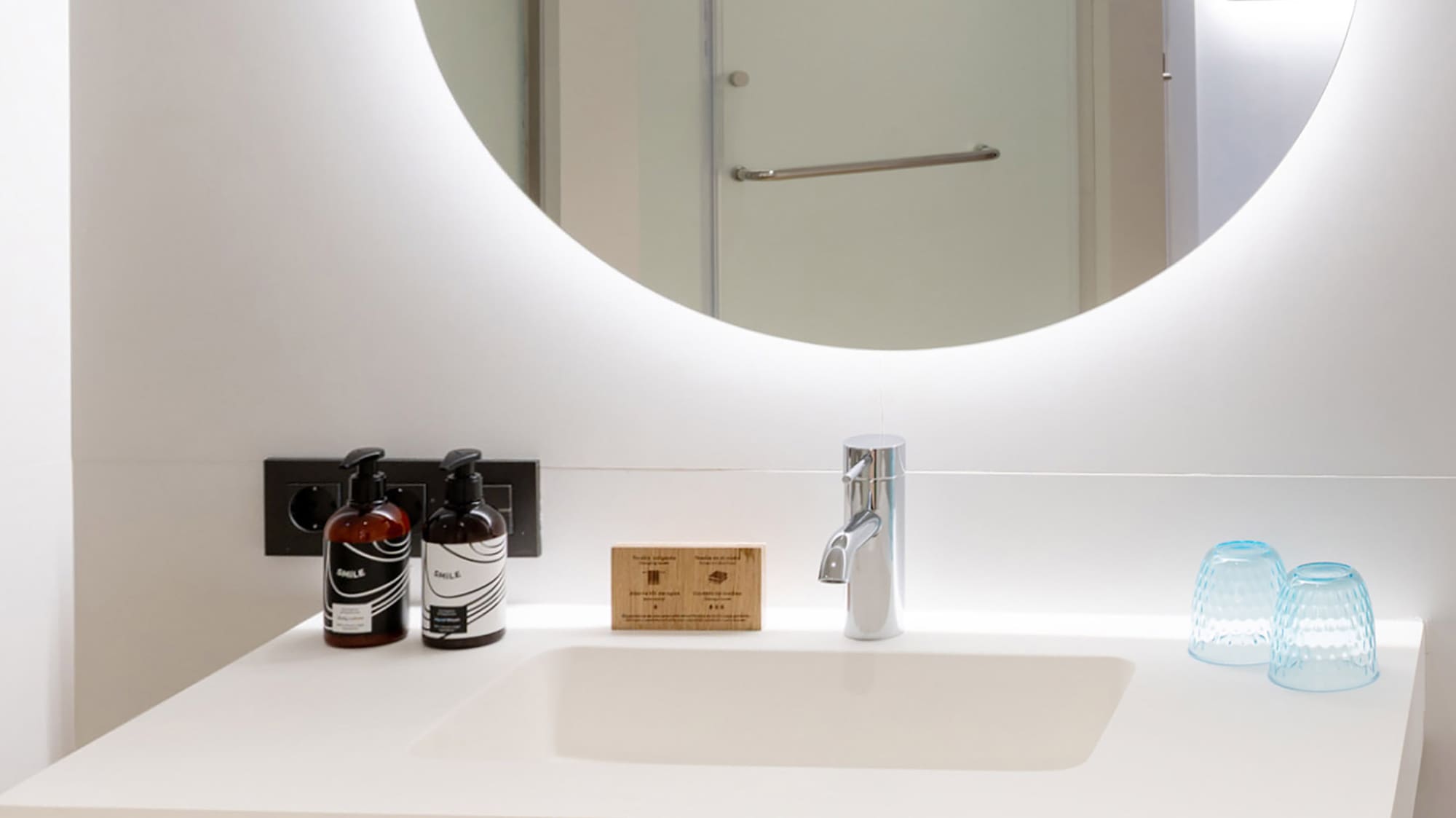 a bathroom with a round mirror