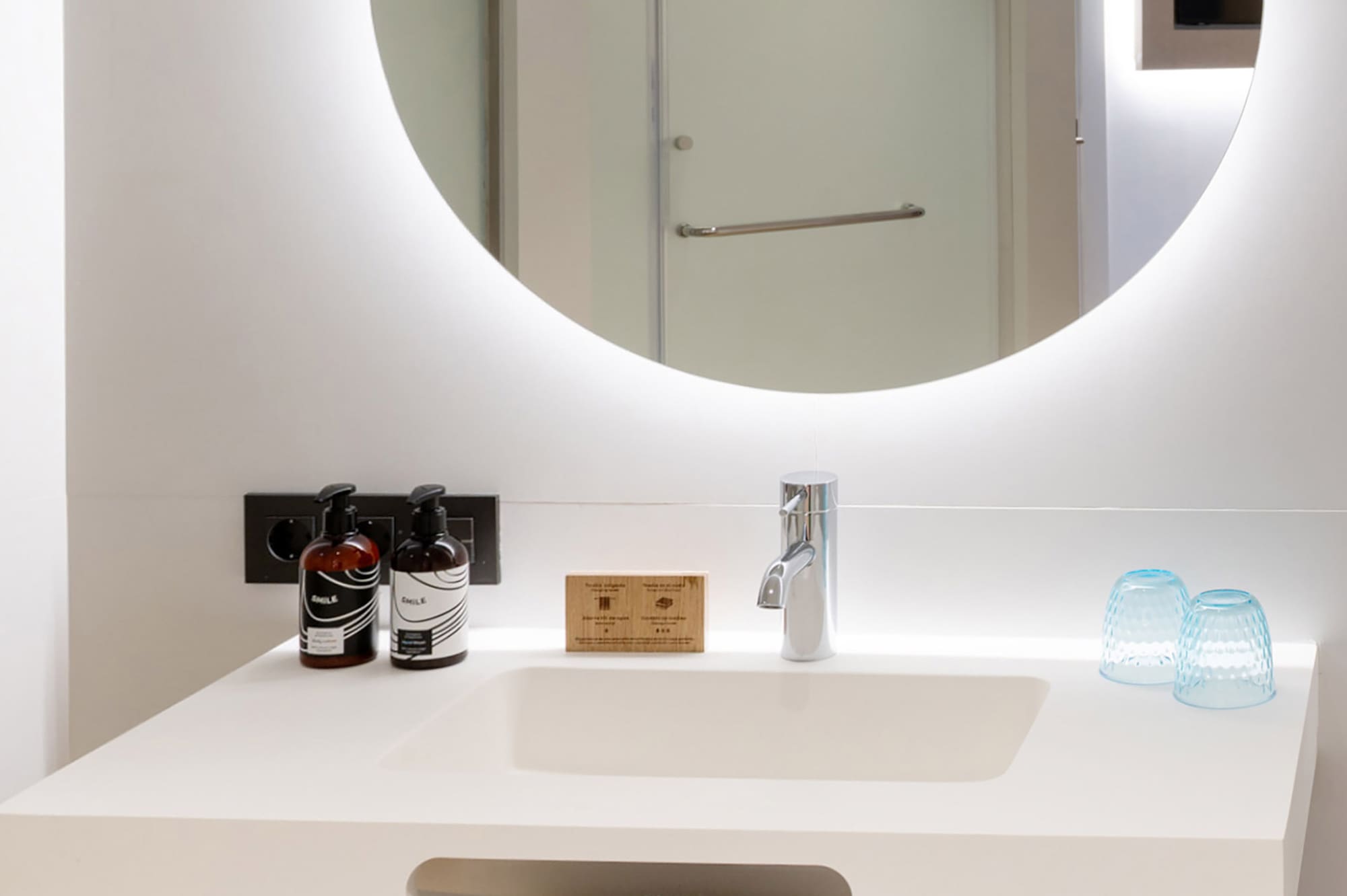 a bathroom with a round mirror