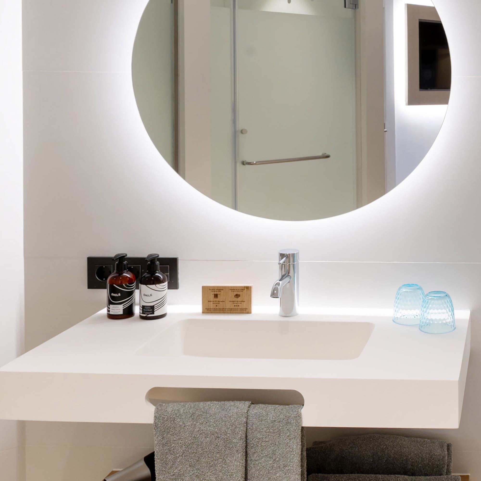 a bathroom with a round mirror
