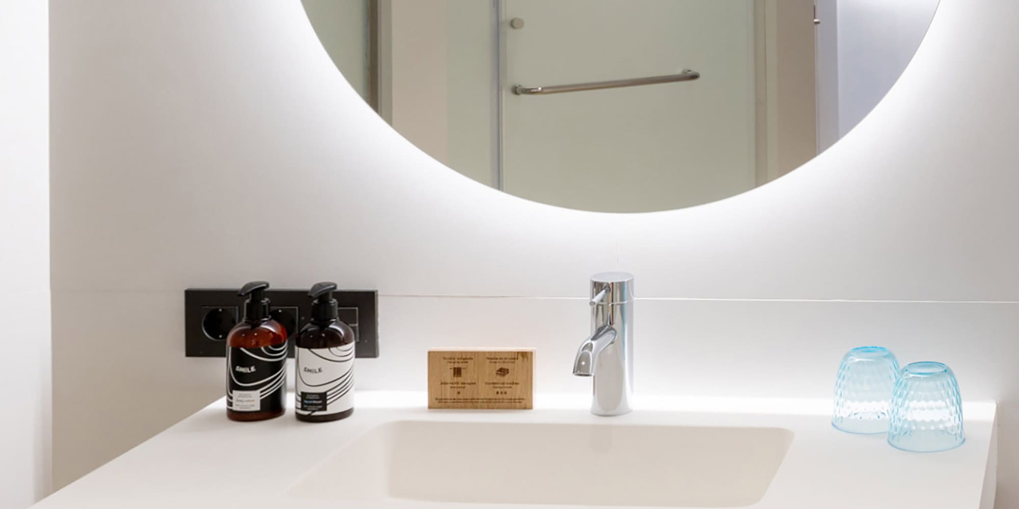 a bathroom with a round mirror