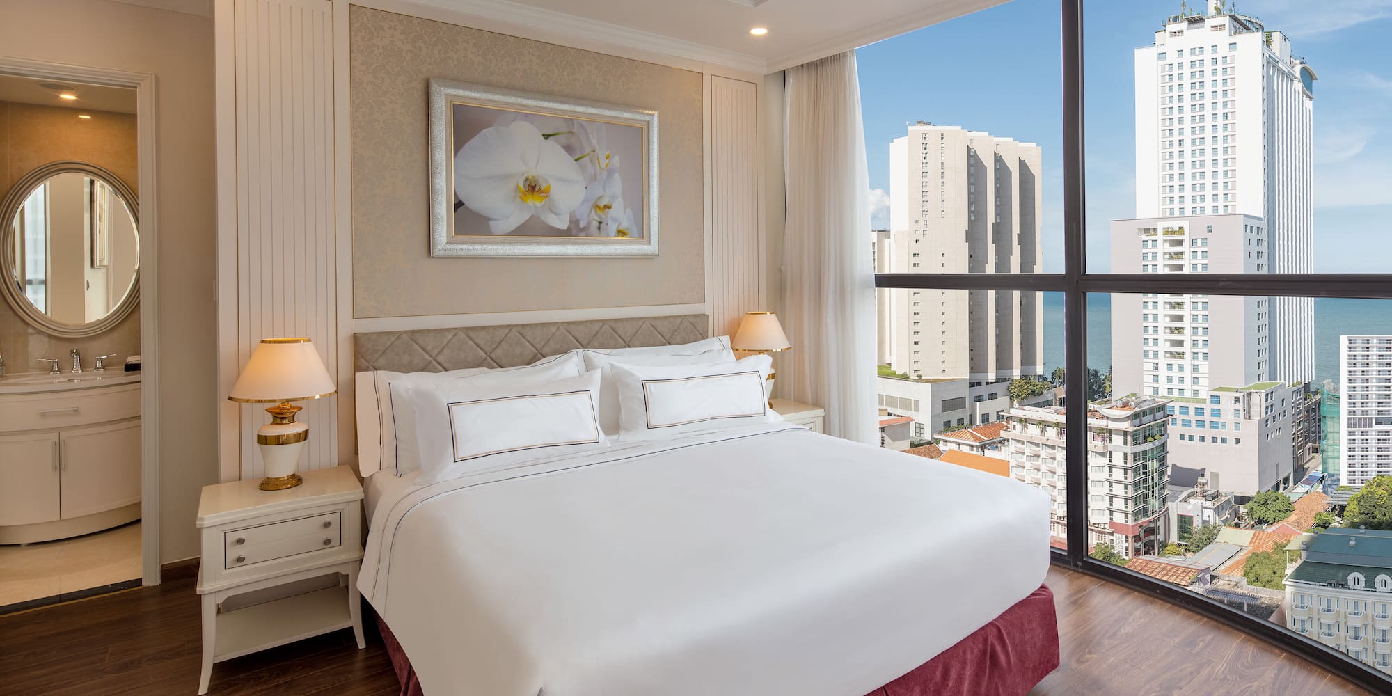 a bedroom with a large window overlooking a city