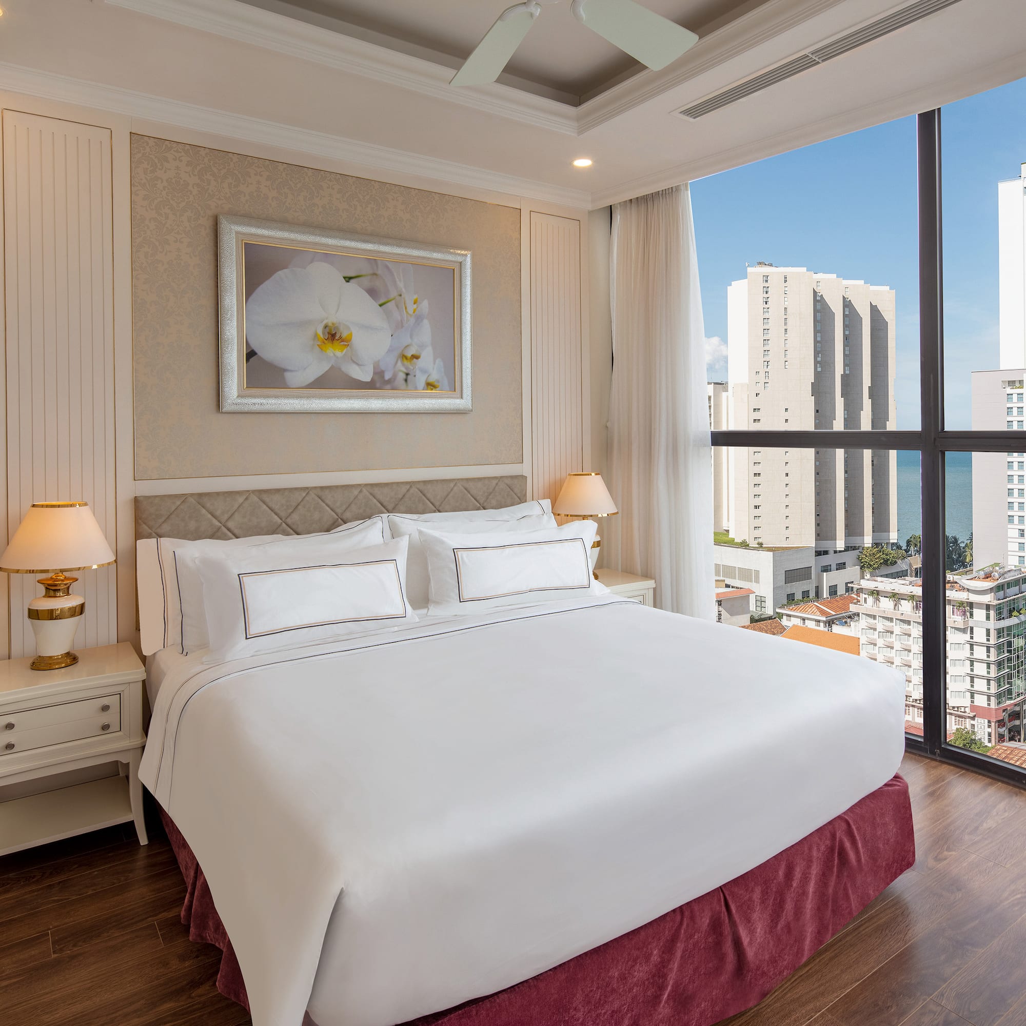 a bedroom with a large window overlooking a city