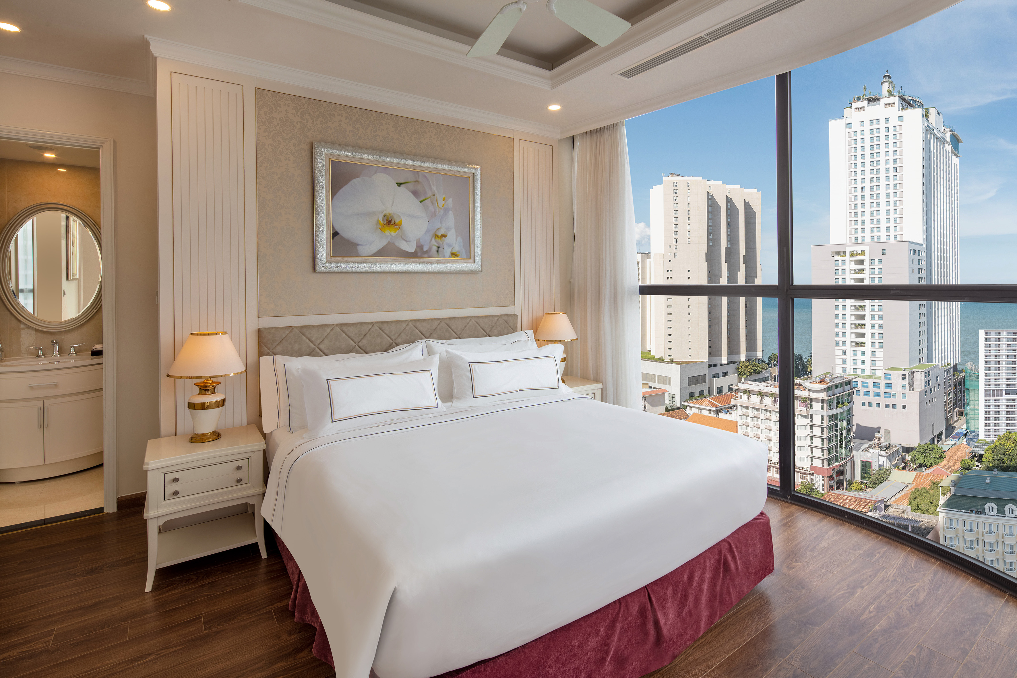 a bedroom with a large window overlooking a city