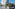 INNSiDE hotel, sandy beach with straw umbrellas, and swimming pool.