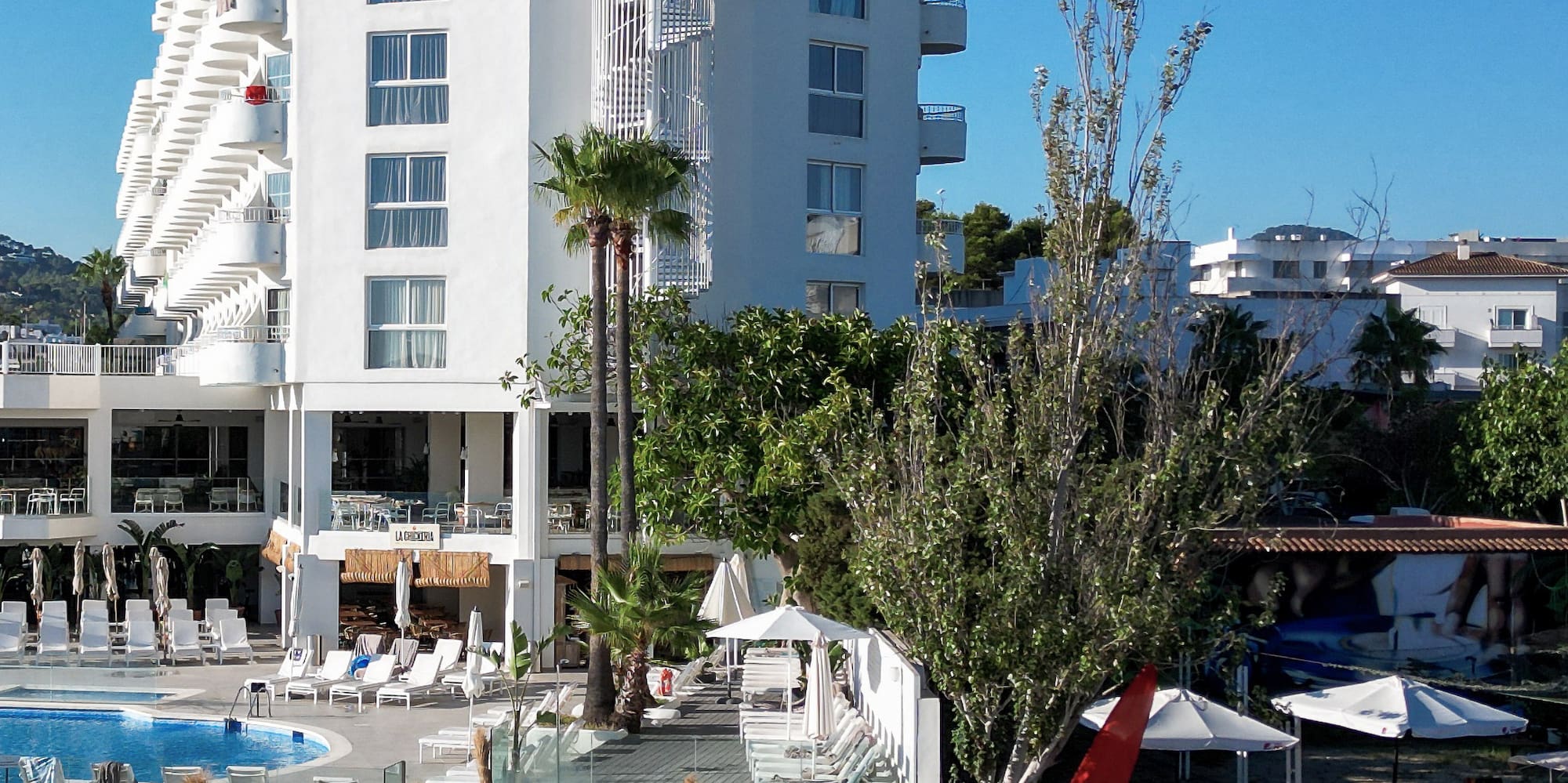 a group of straw umbrellas next to a building