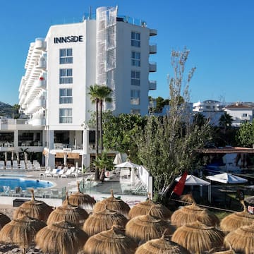 a group of straw umbrellas next to a building