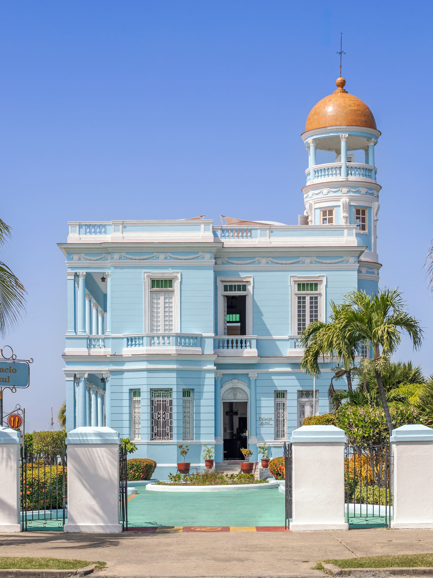 a blue and white building with a gold dome
