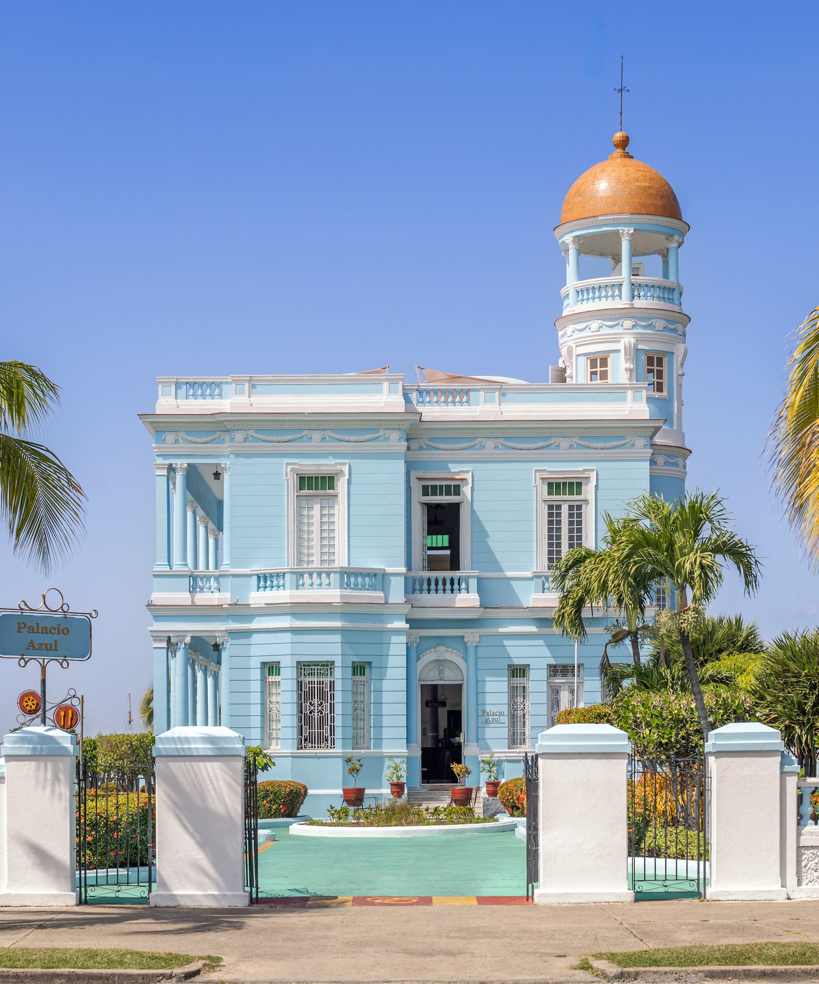 a blue and white building with a gold dome