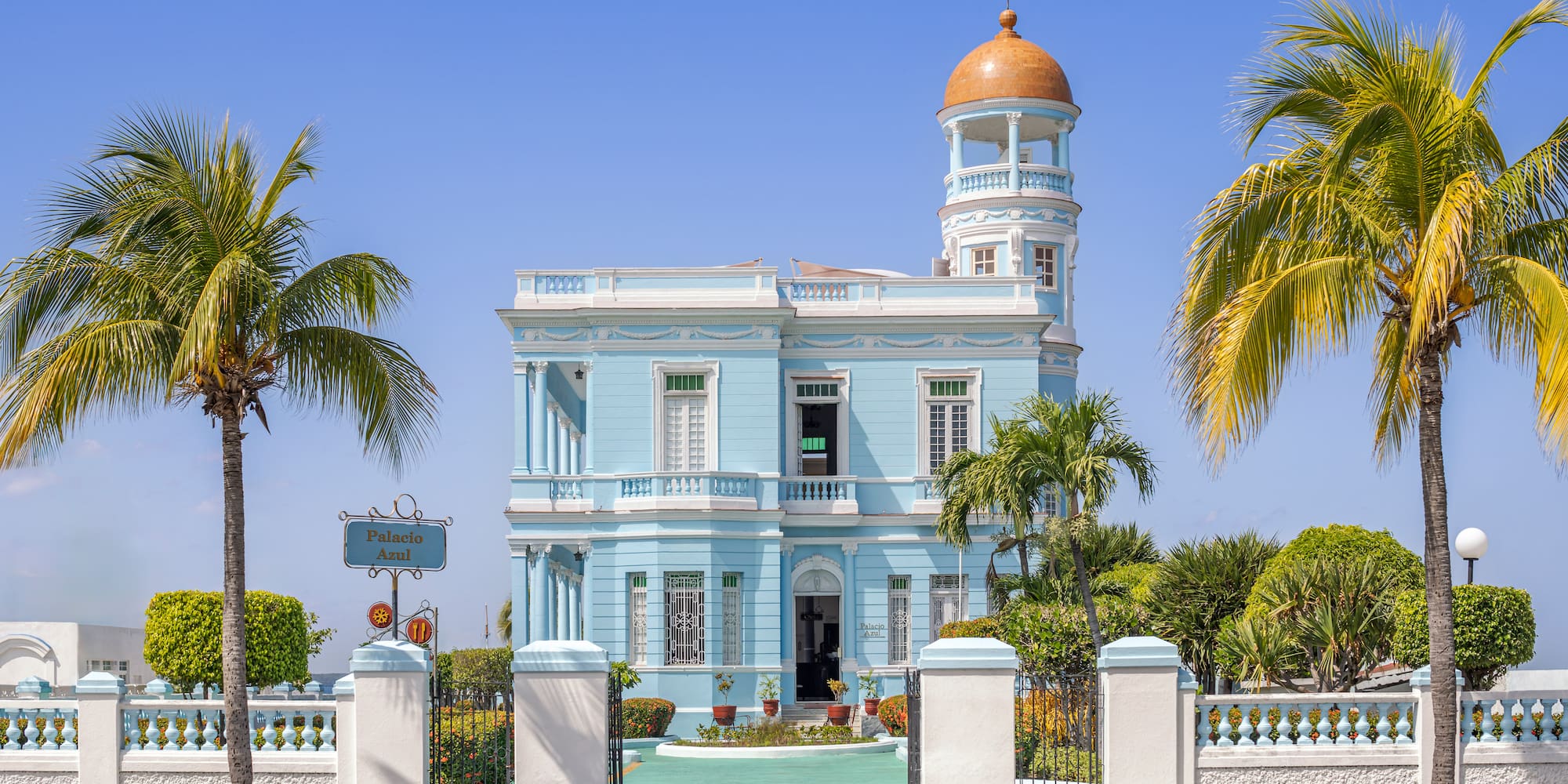 a blue and white building with a gold dome
