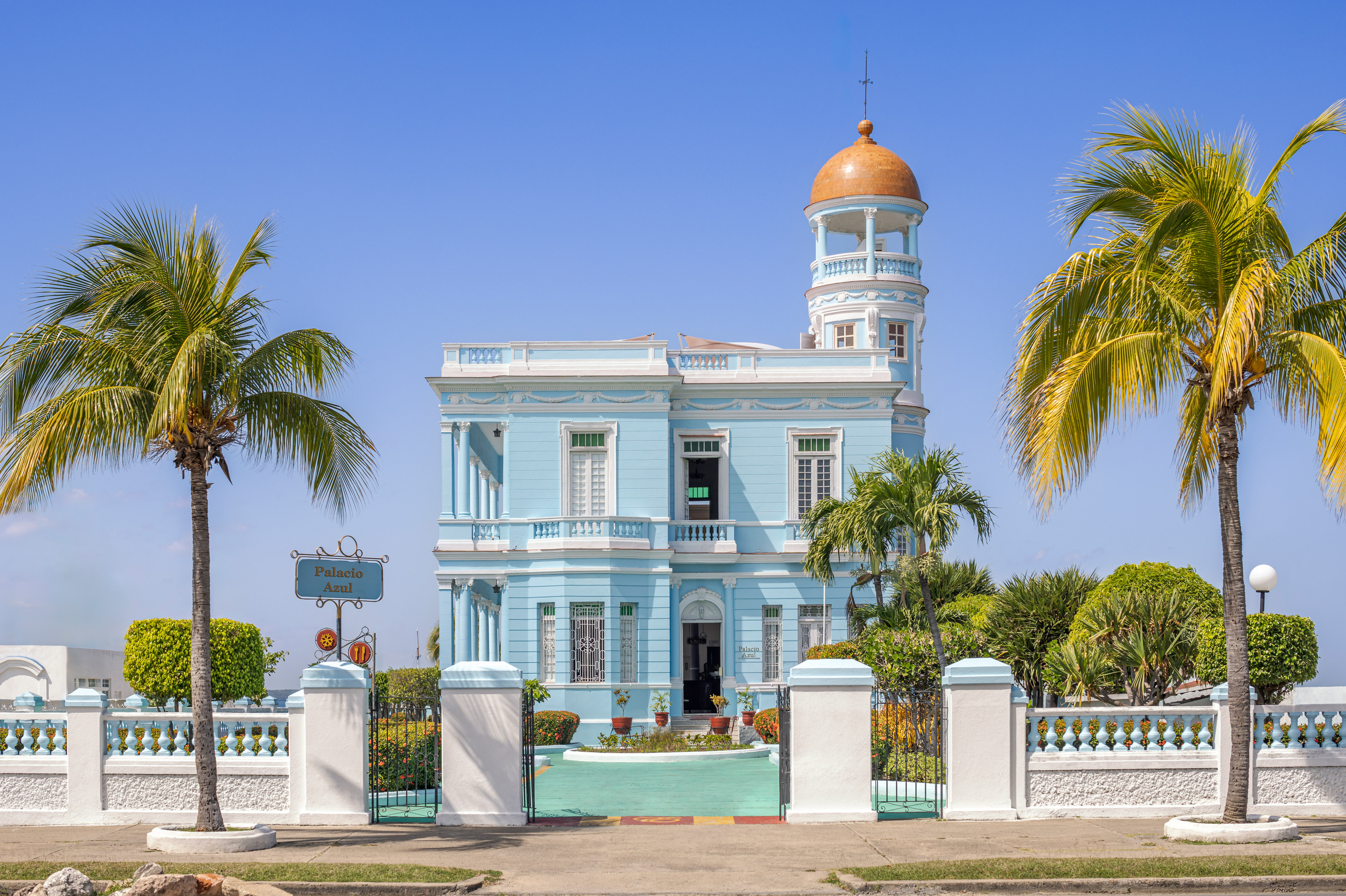 a blue and white building with a gold dome