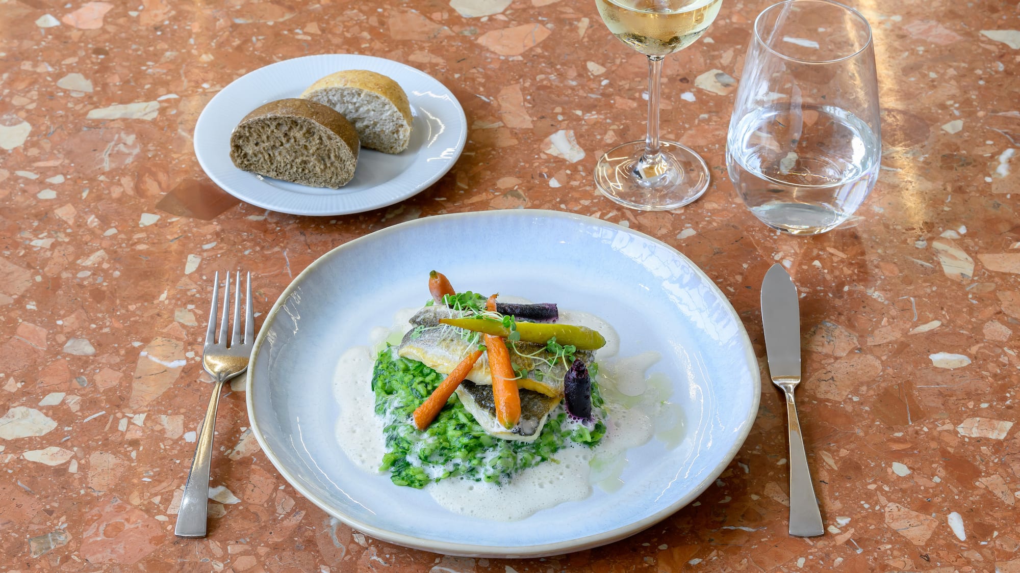 a plate of food and a glass of wine