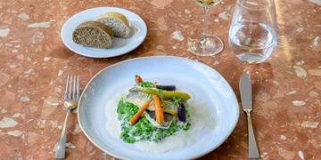 a plate of food and a glass of wine