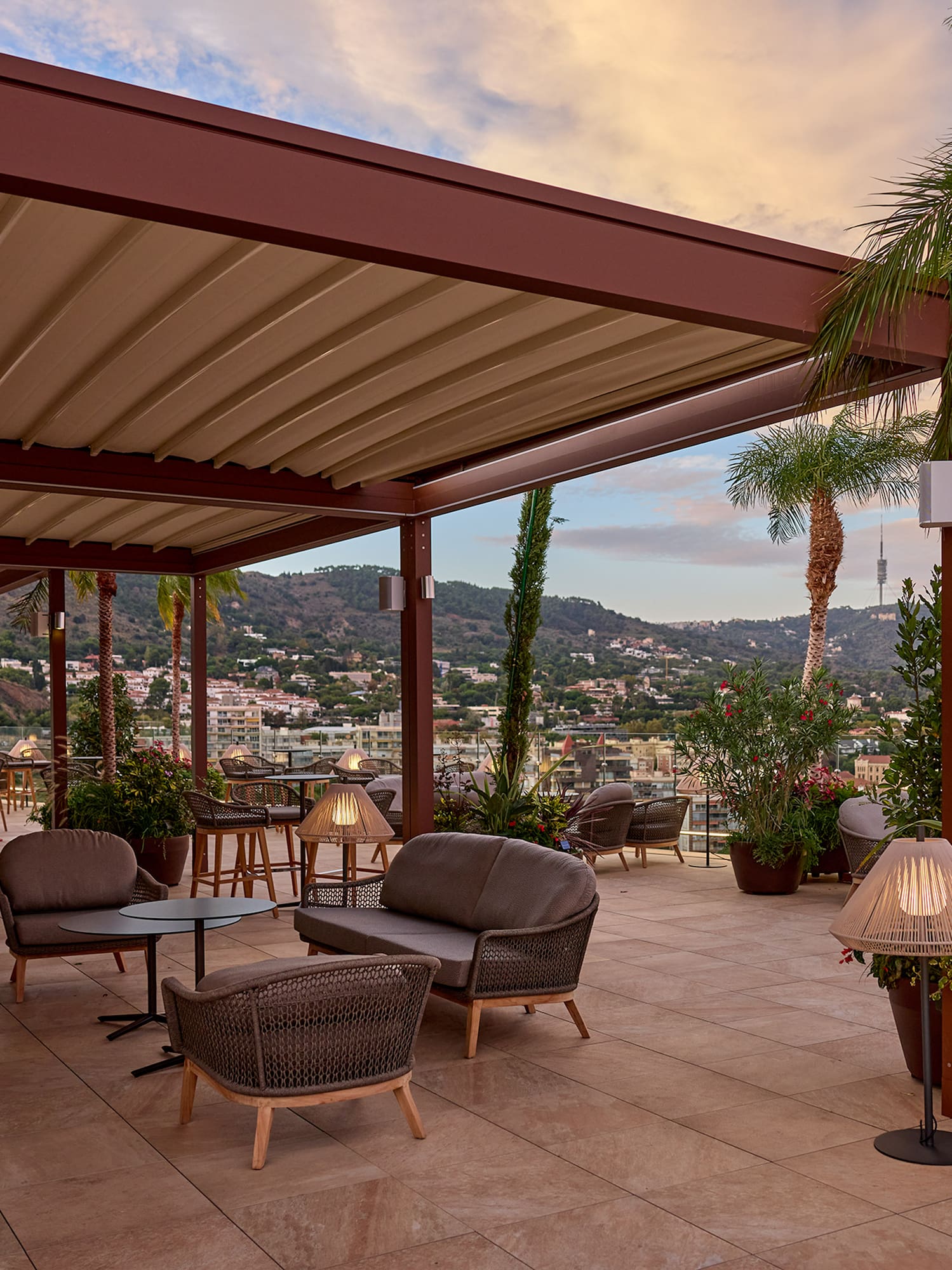 a patio with chairs and tables and plants