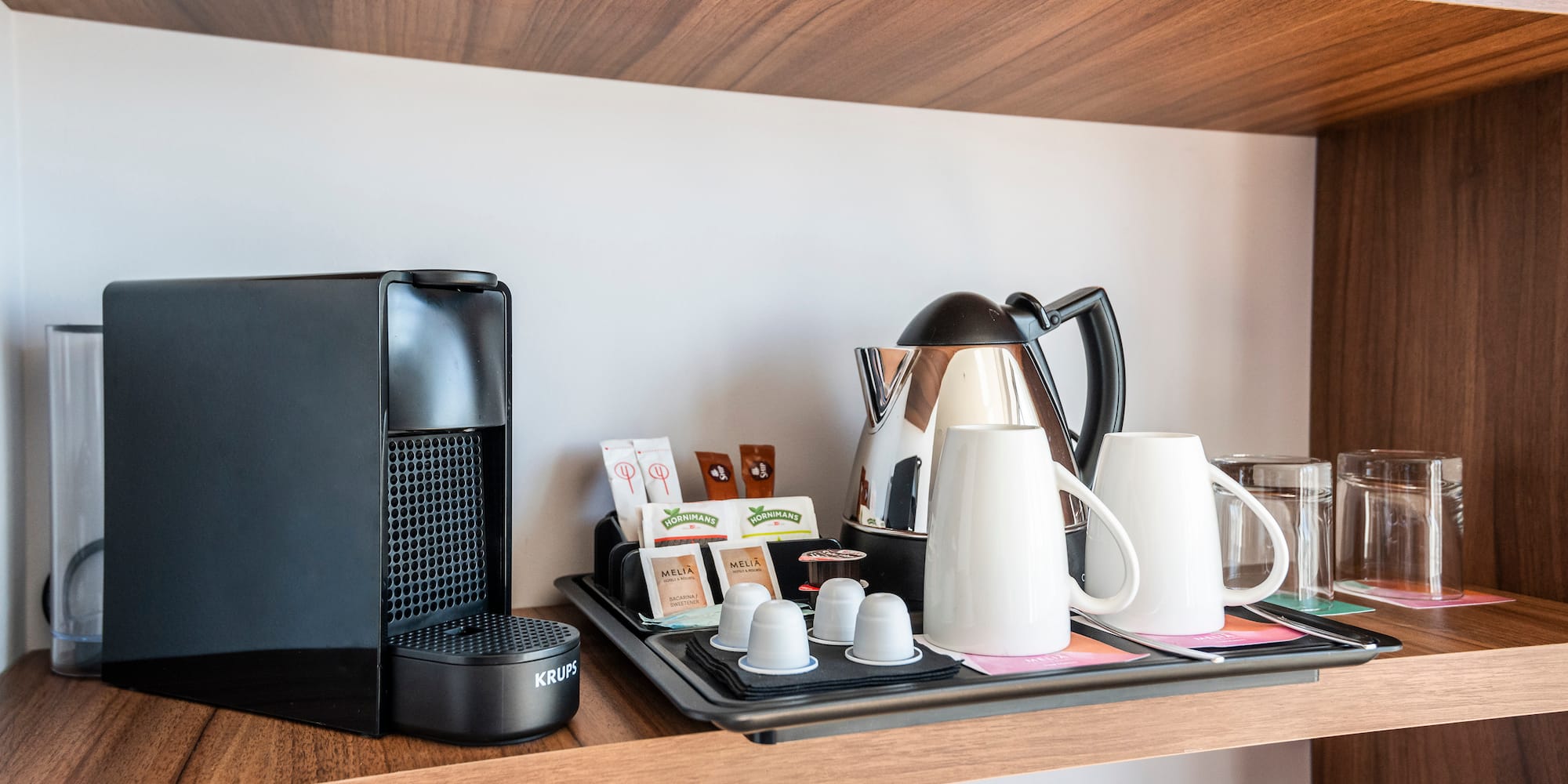 a coffee maker and coffee machine on a shelf