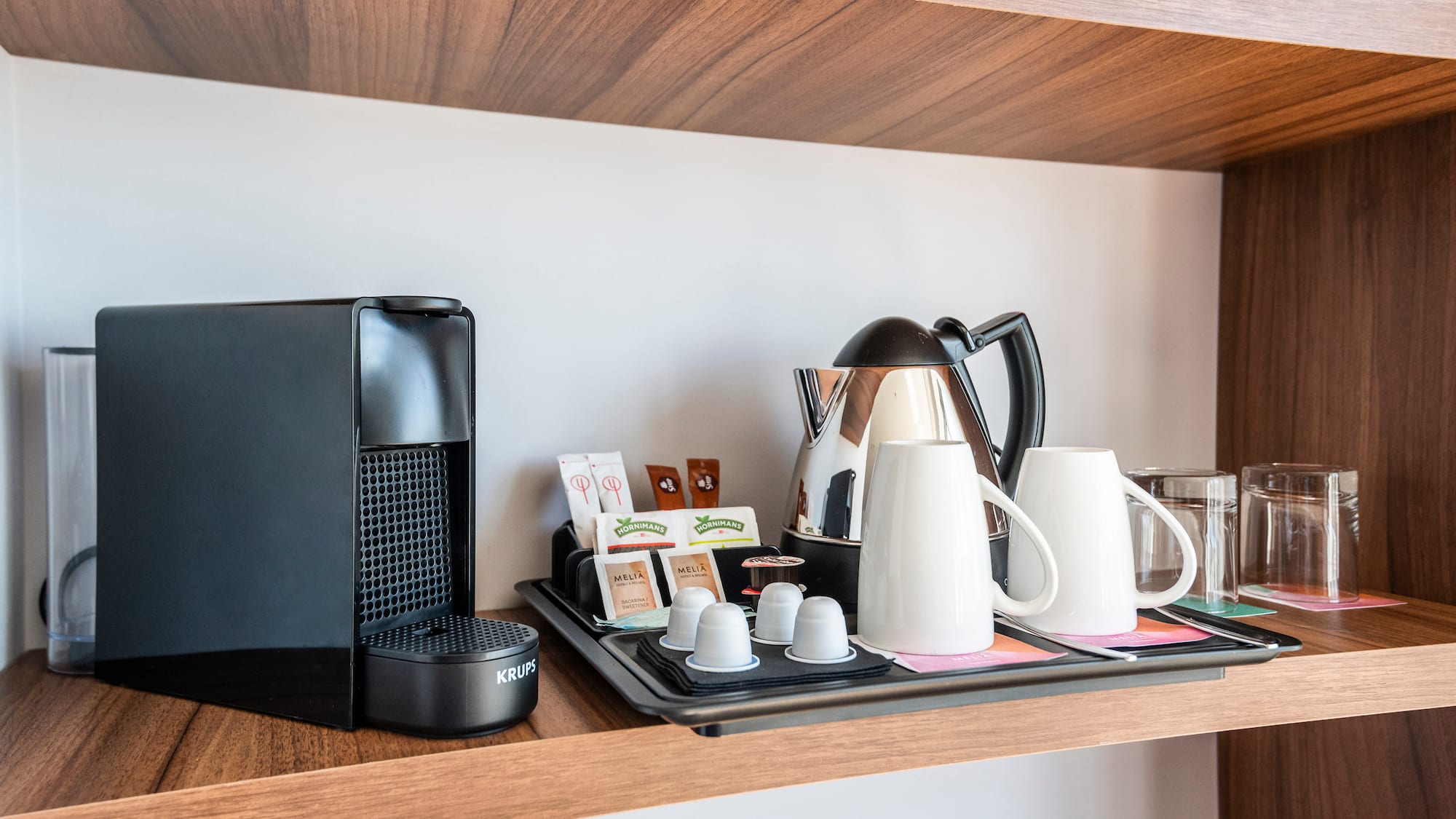 a coffee maker and coffee machine on a shelf