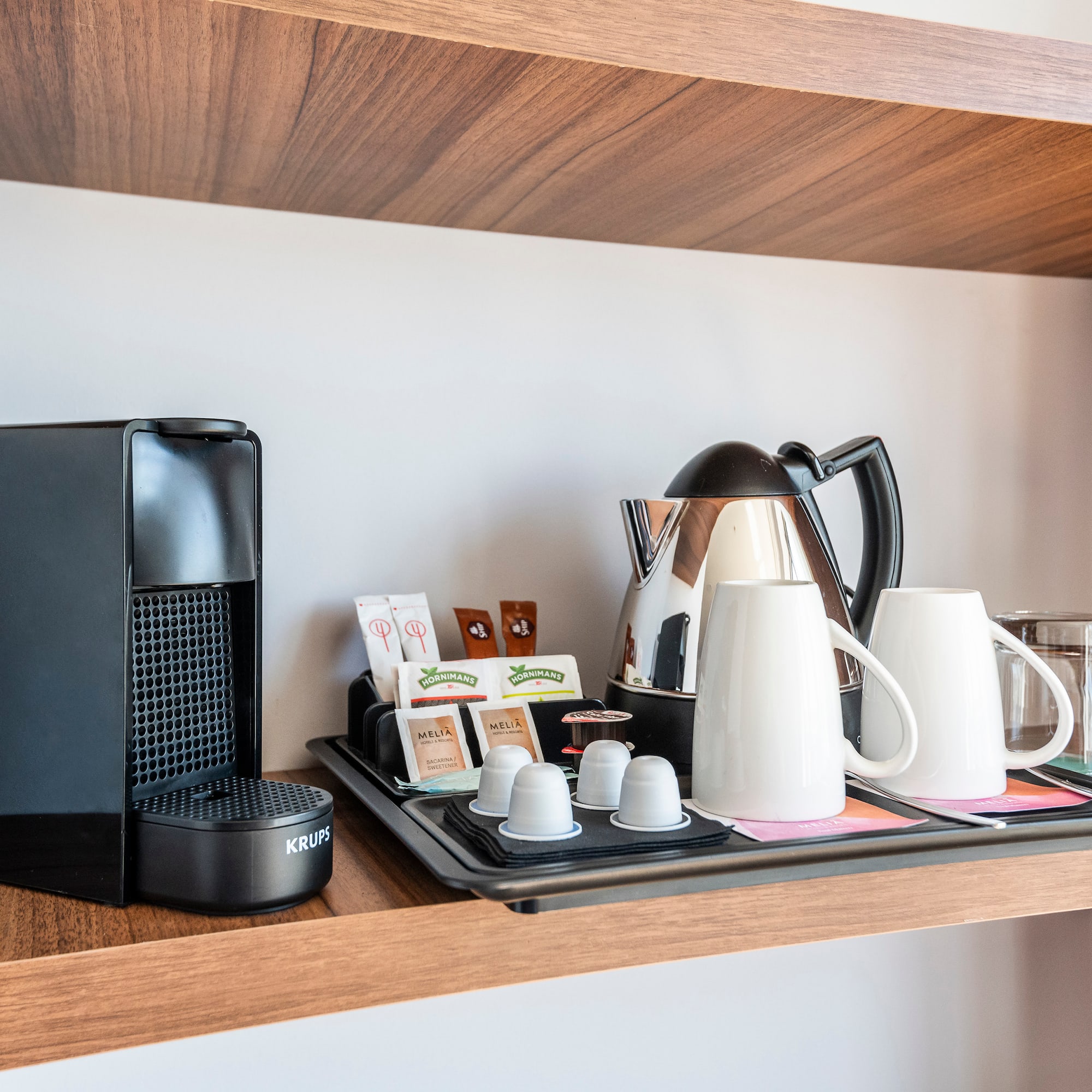 a coffee maker and coffee machine on a shelf