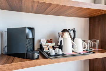 a coffee maker and coffee machine on a shelf