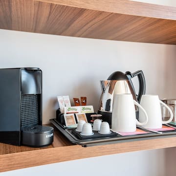 a coffee maker and coffee machine on a shelf