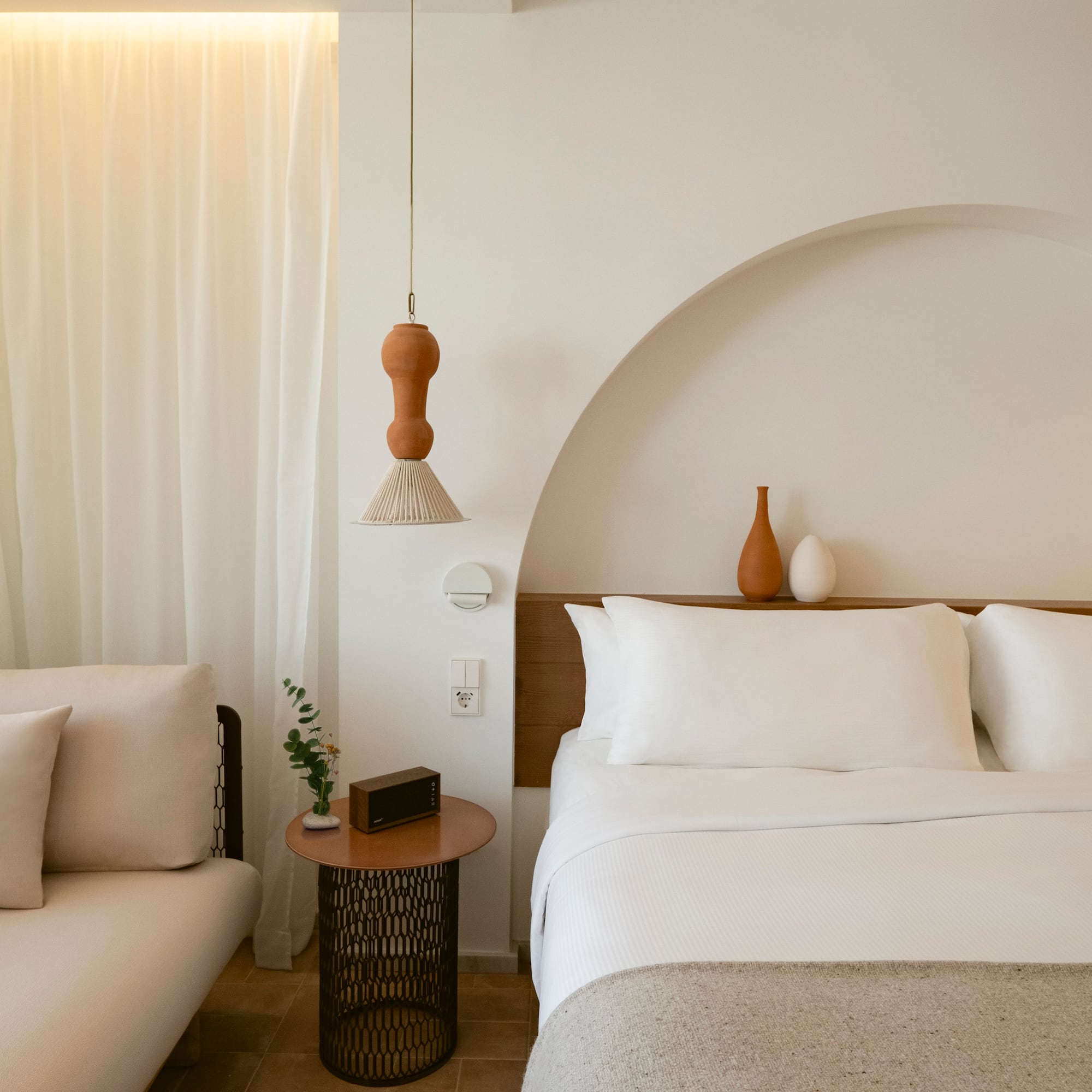 a bed with pillows and a couch in a room