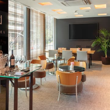 a room with a table and chairs and a television