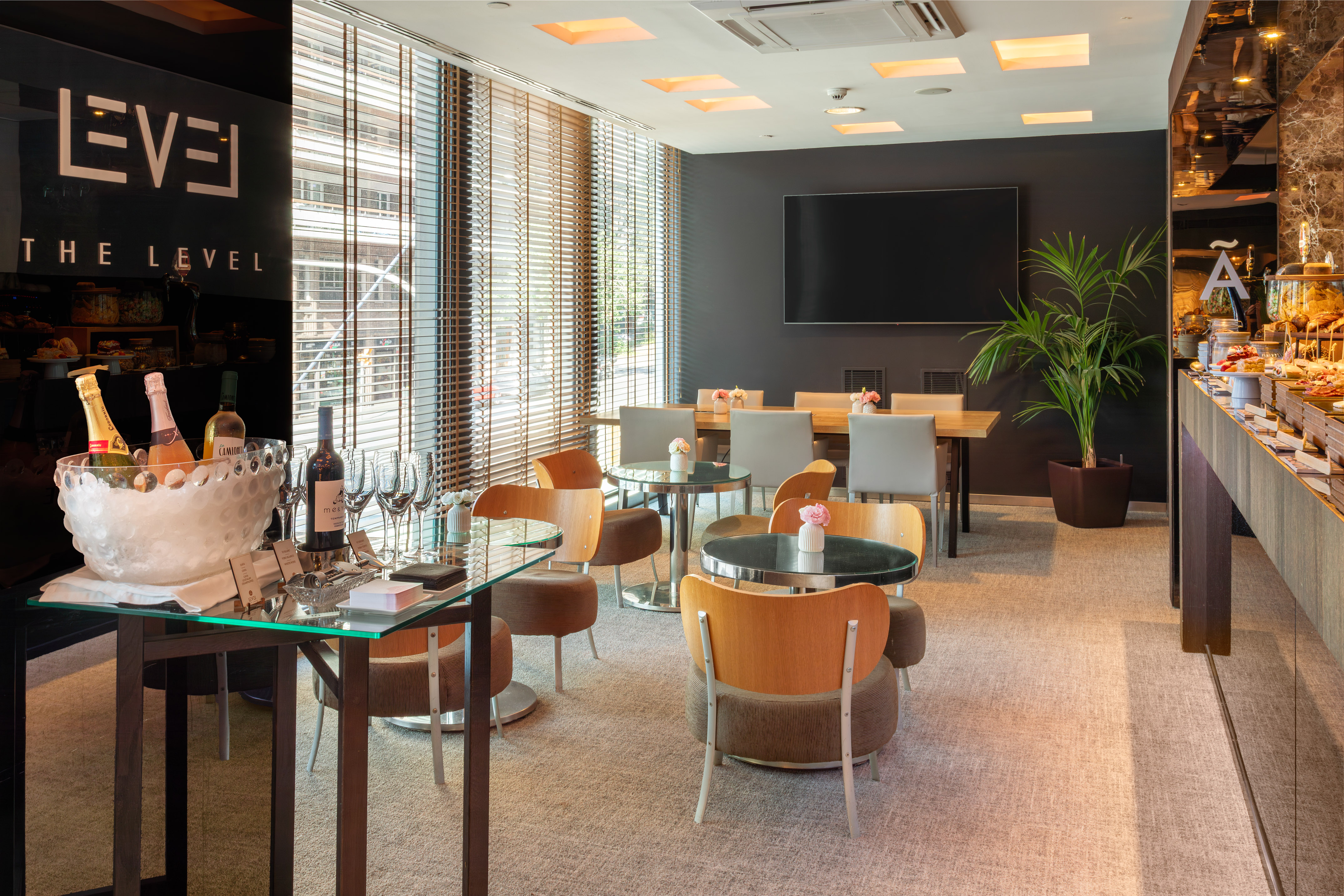 "The Level" executive lounge with drinks bar, buffet, and modern seating areas.