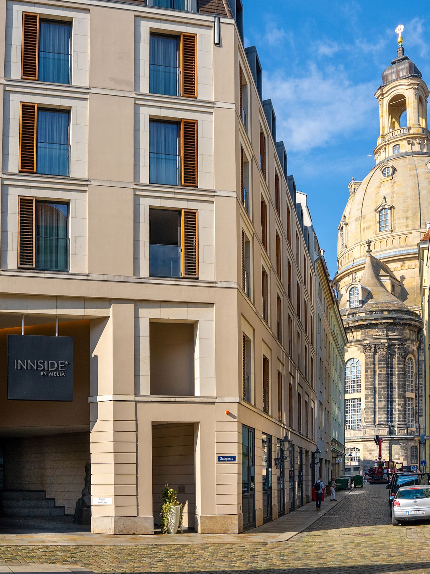 a street with cars parked in front of a building