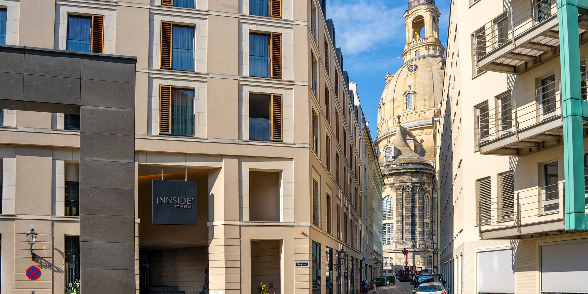 a street with cars parked in front of a building