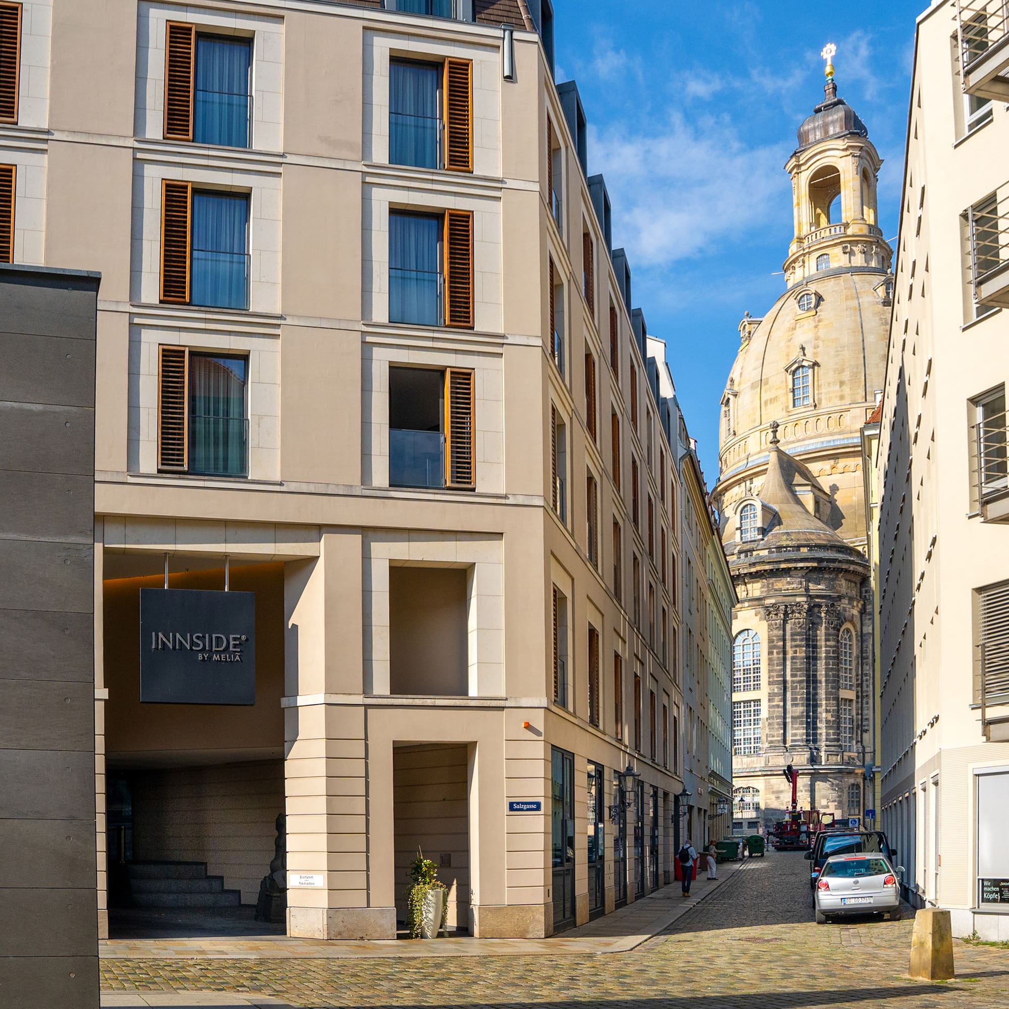 a street with cars parked in front of a building