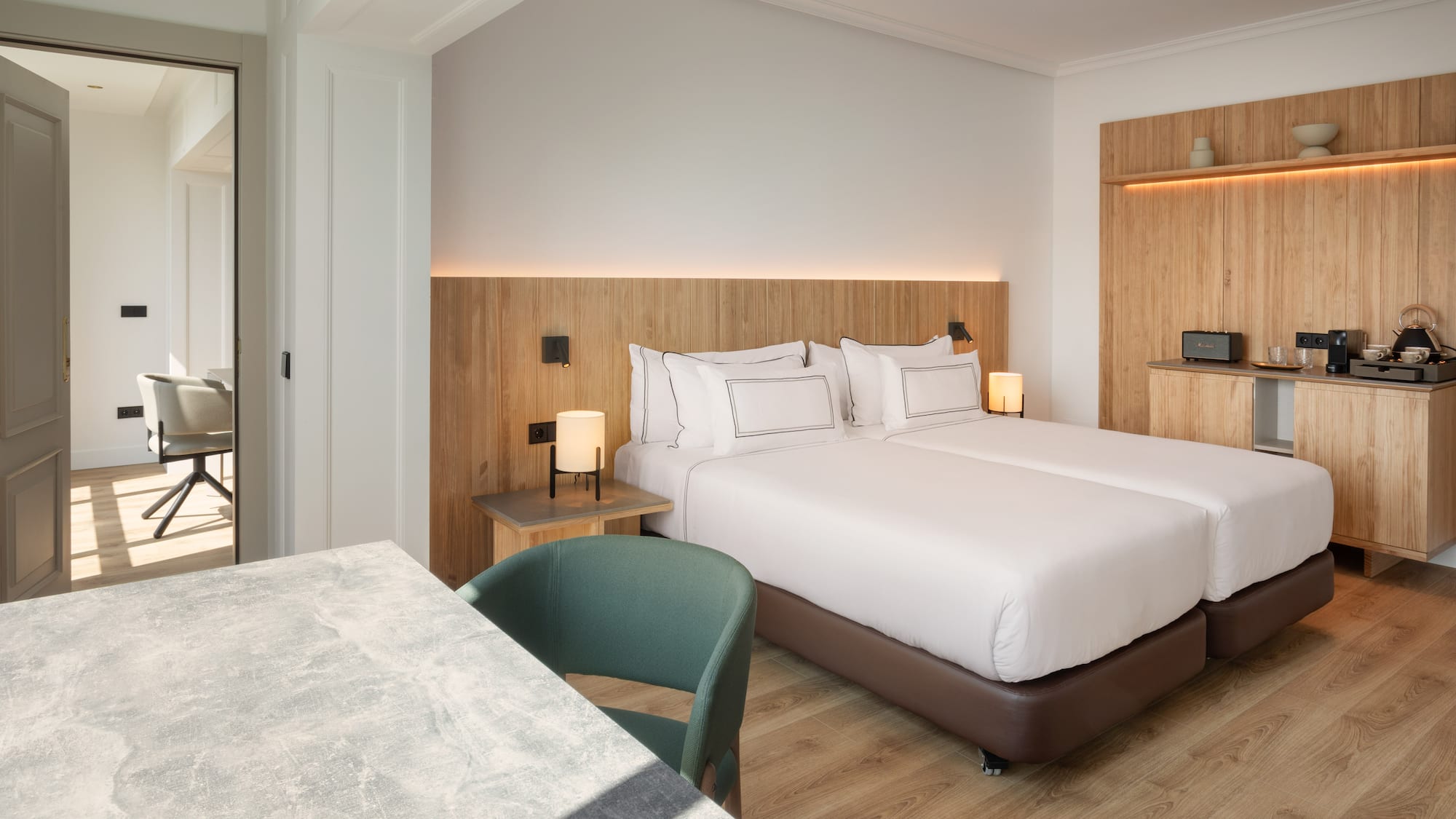 a room with two beds and a table