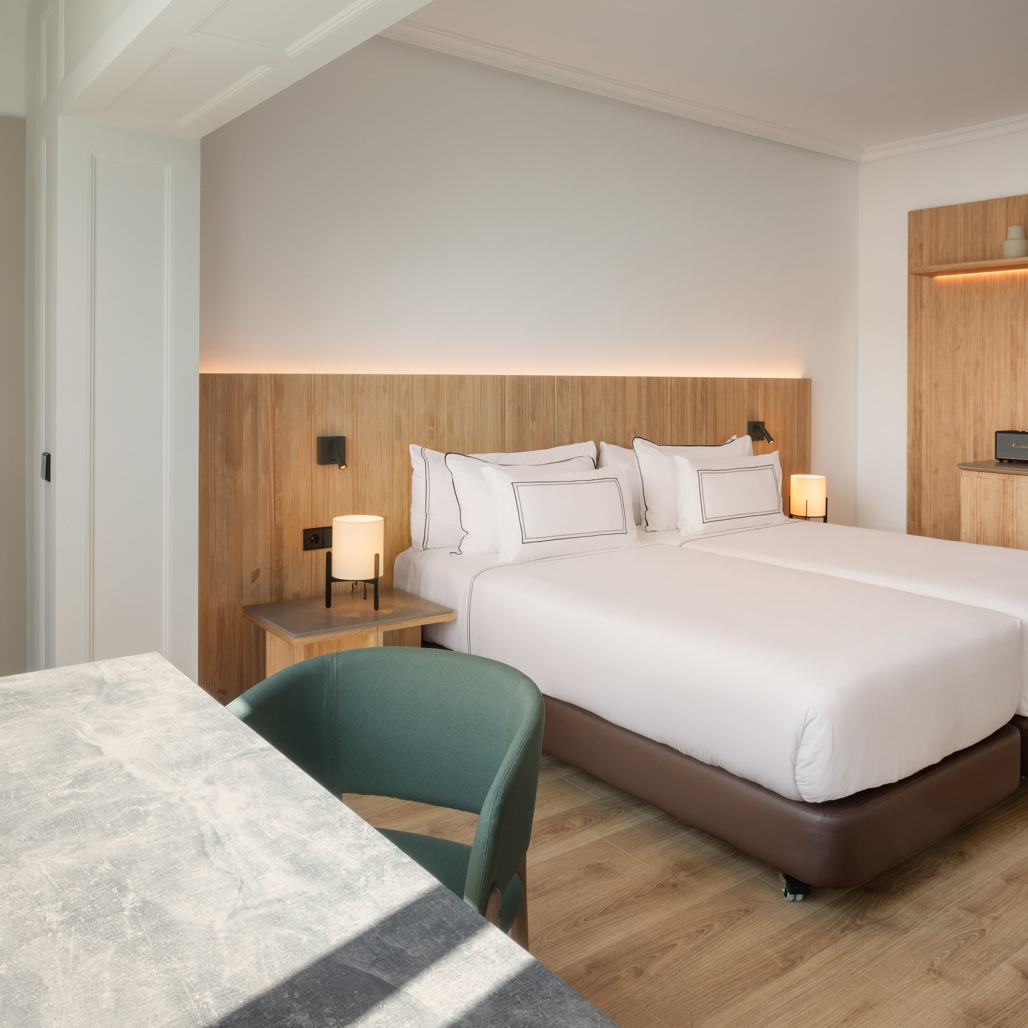 a room with two beds and a table