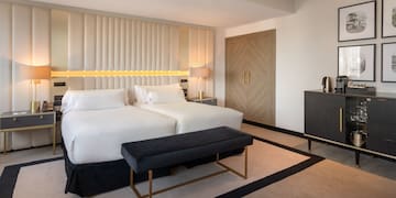 a room with a bed and a bench