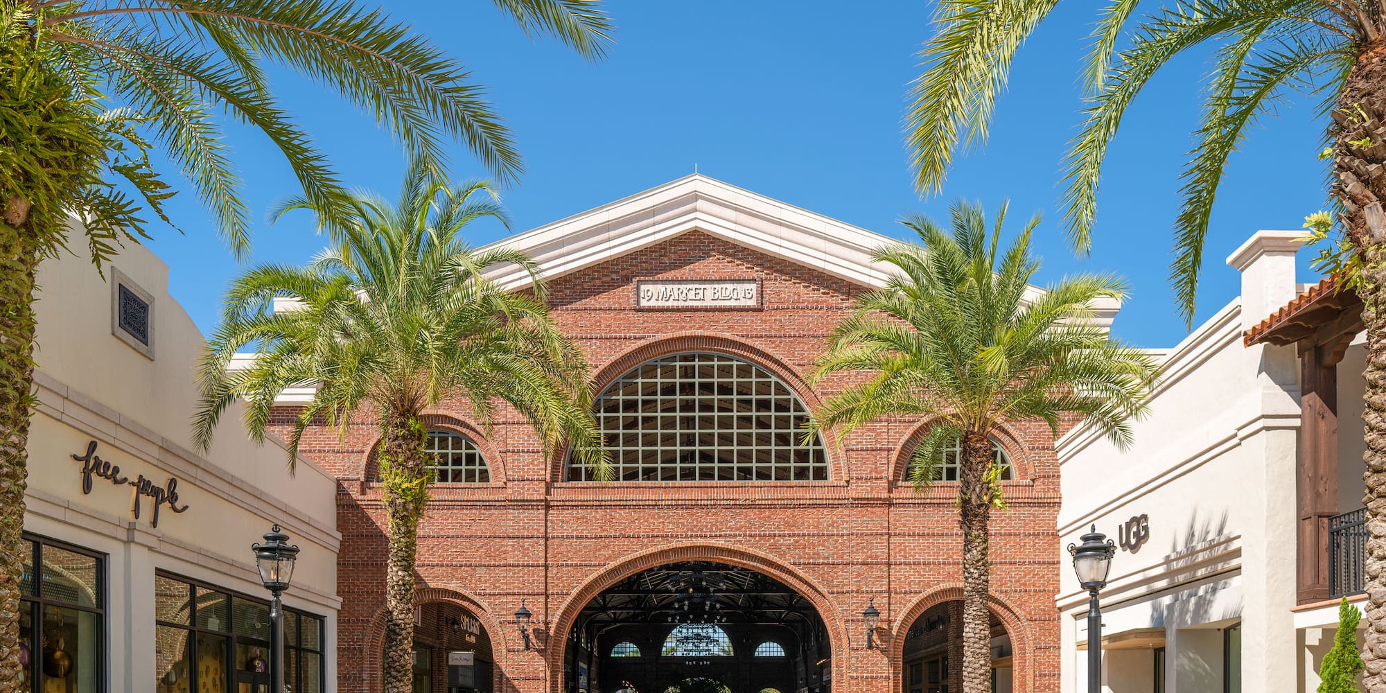 a group of people walking in a shopping mall