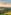 Helicopter flying above green rolling hills, golden sunset. Tuscany landscape.