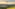 Helicopter flying above green rolling hills, golden sunset. Tuscany landscape.
