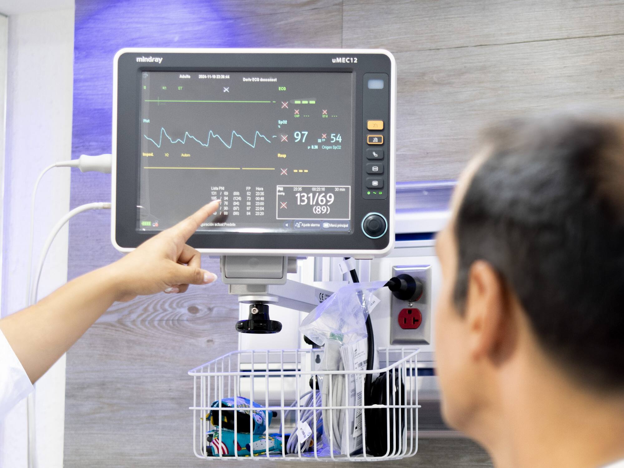 a person pointing at a monitor