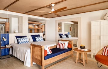 a room with a bed and a fan