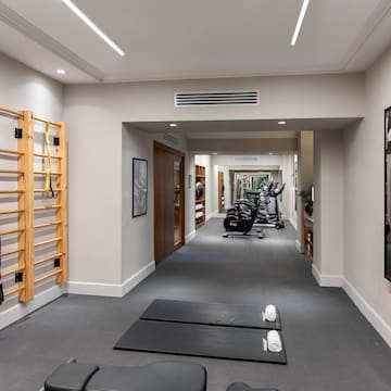 a room with exercise equipment and a wall bar