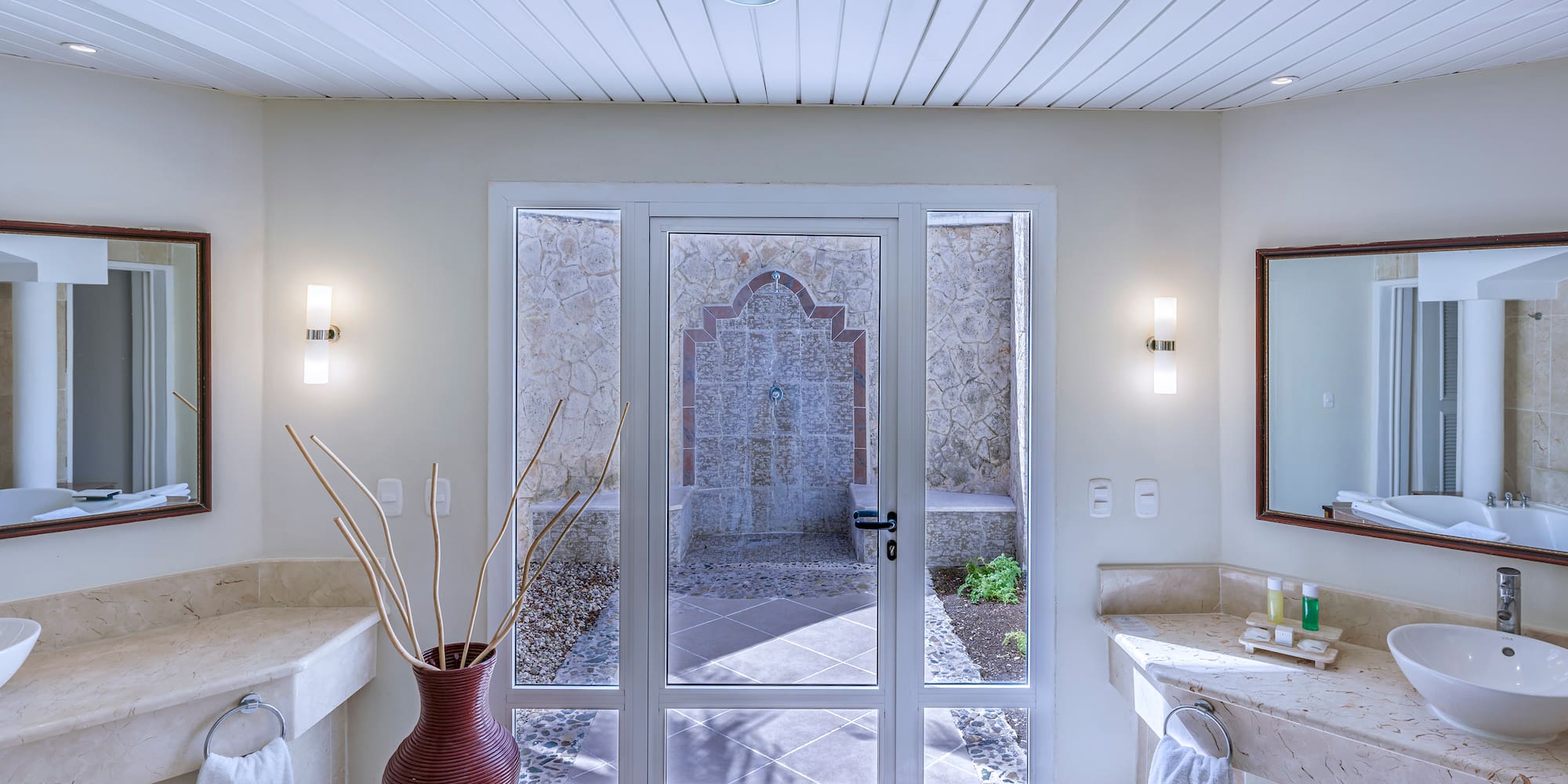 a bathroom with a glass door and a sink
