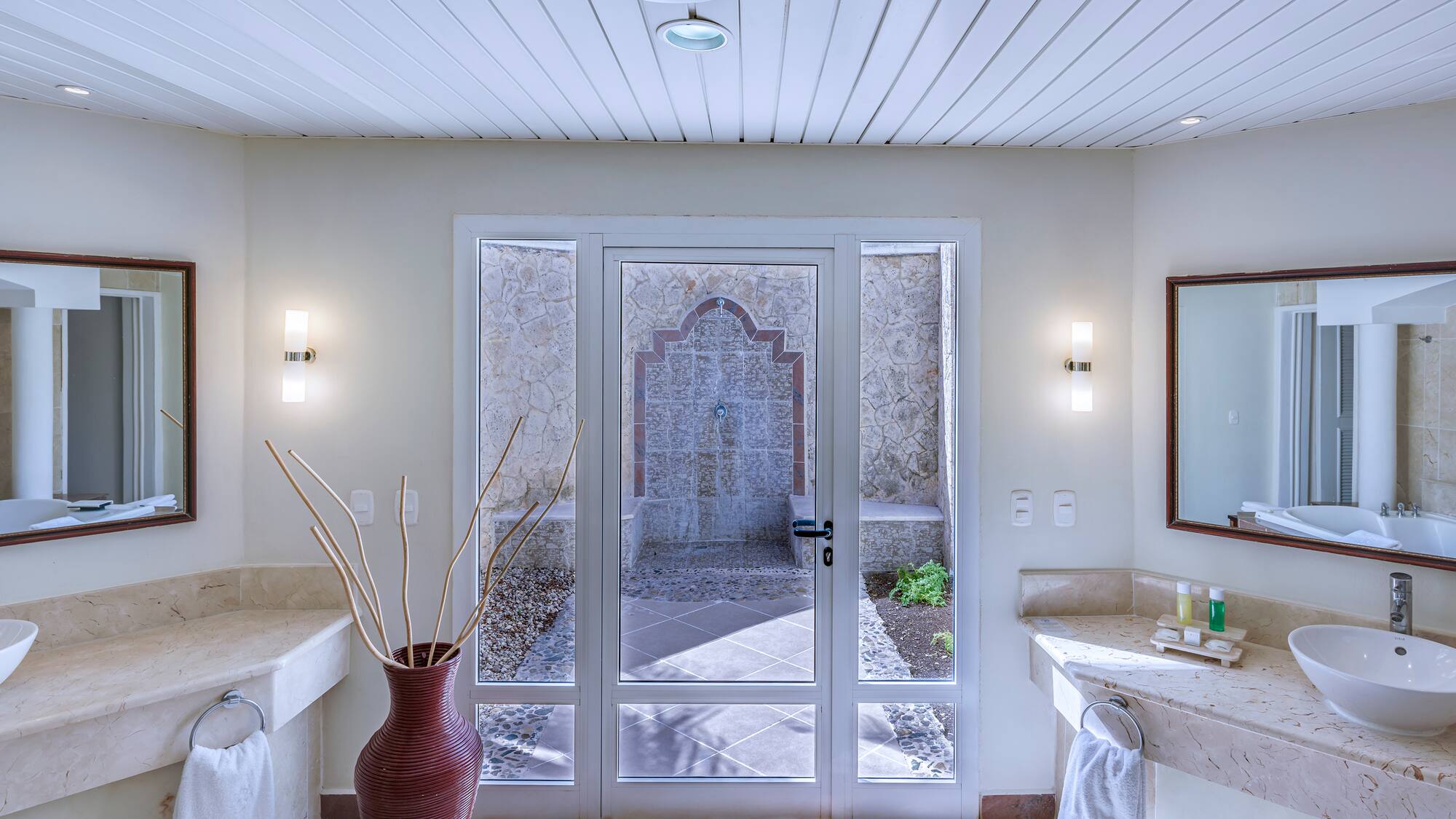 a bathroom with a glass door and a sink