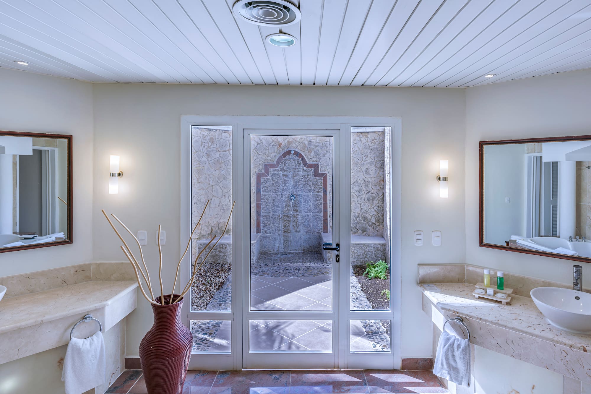 a bathroom with a glass door and a sink