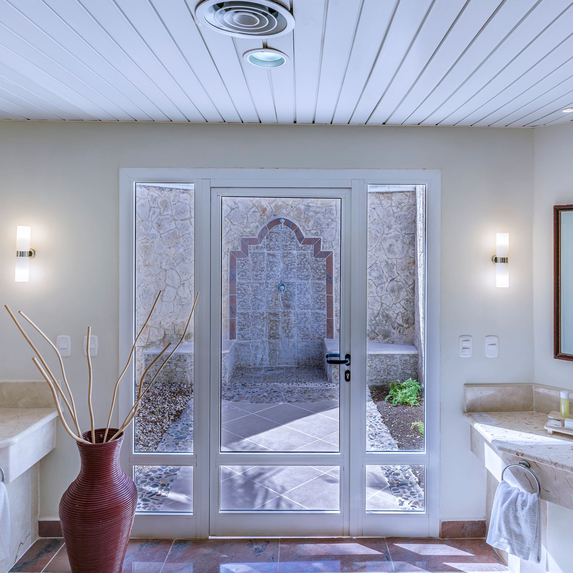 a bathroom with a glass door and a sink