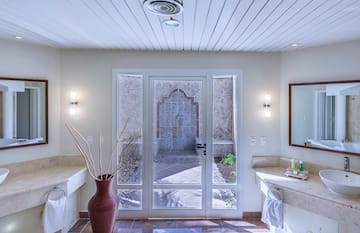a bathroom with a glass door and a sink
