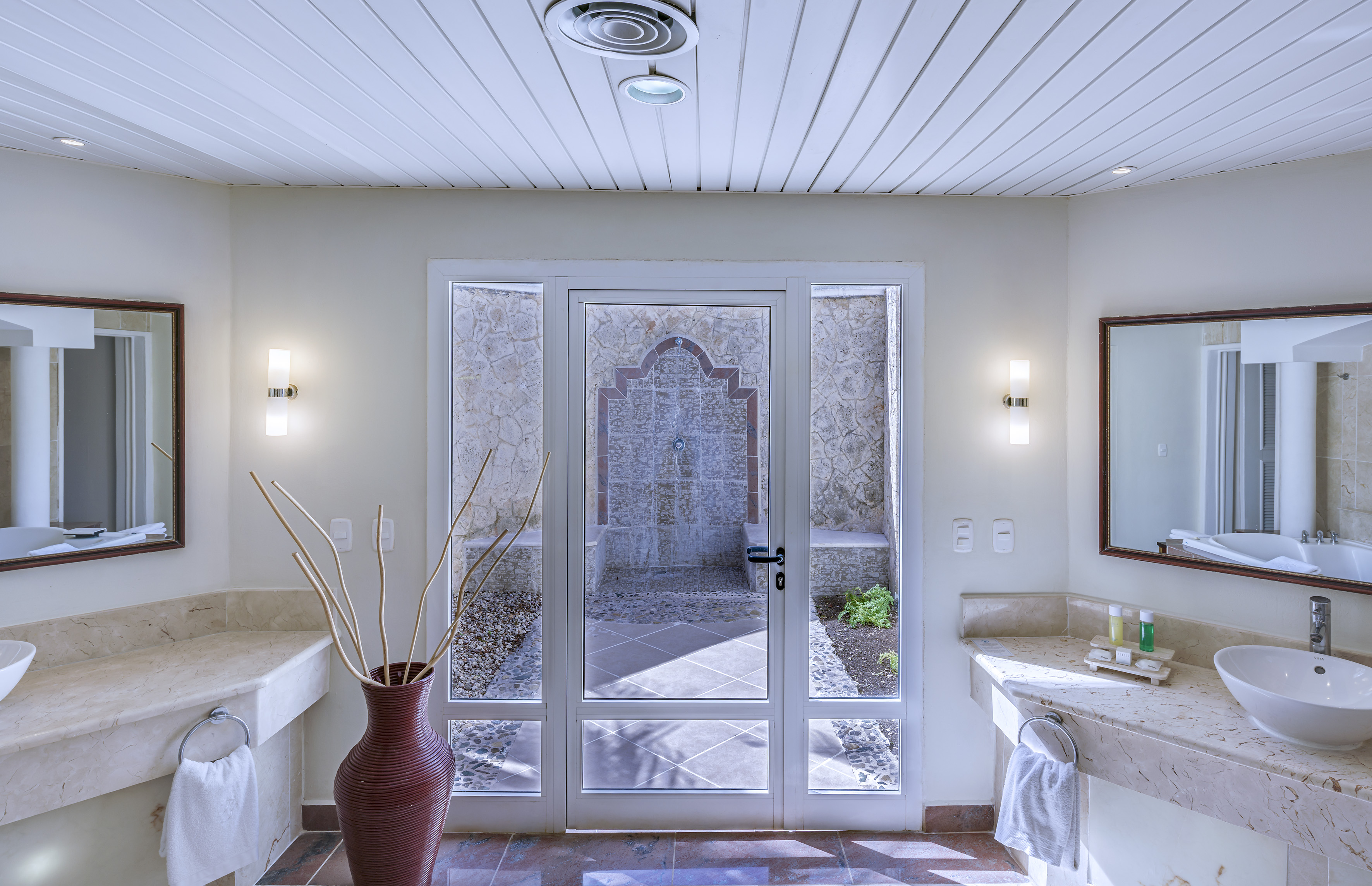 a bathroom with a glass door and a sink