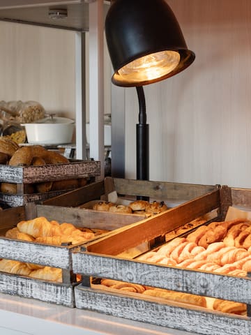 a trays of pastries and bread in a bakery