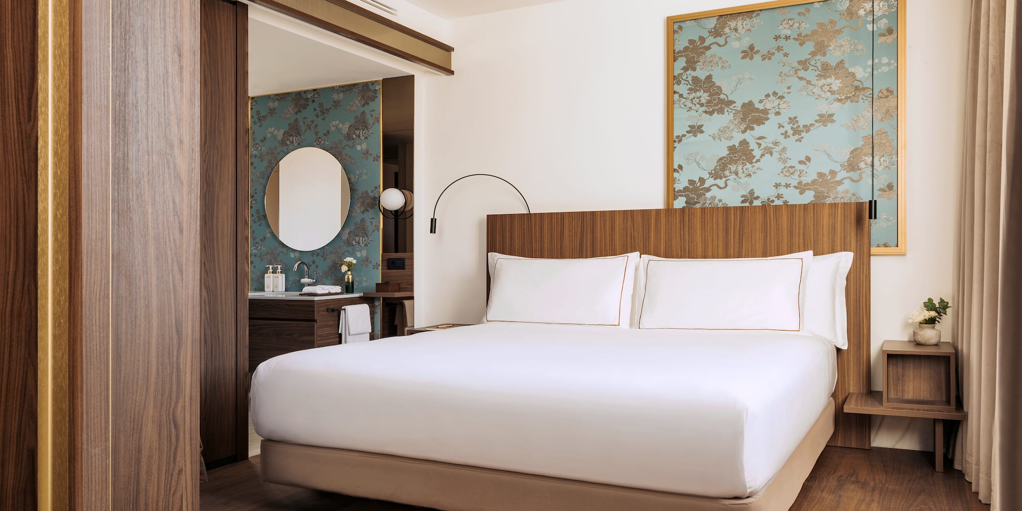 a bedroom with a bed and a mirror