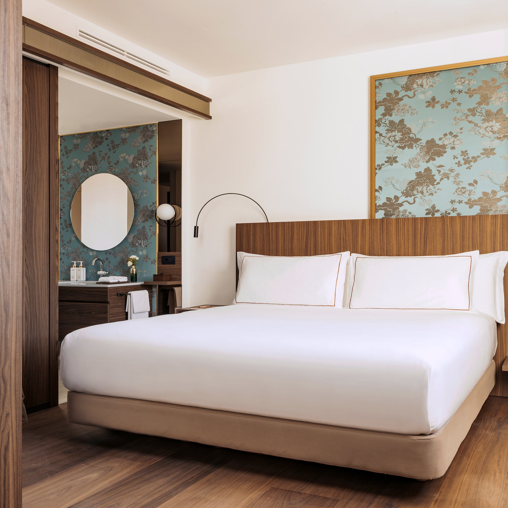 a bedroom with a bed and a mirror