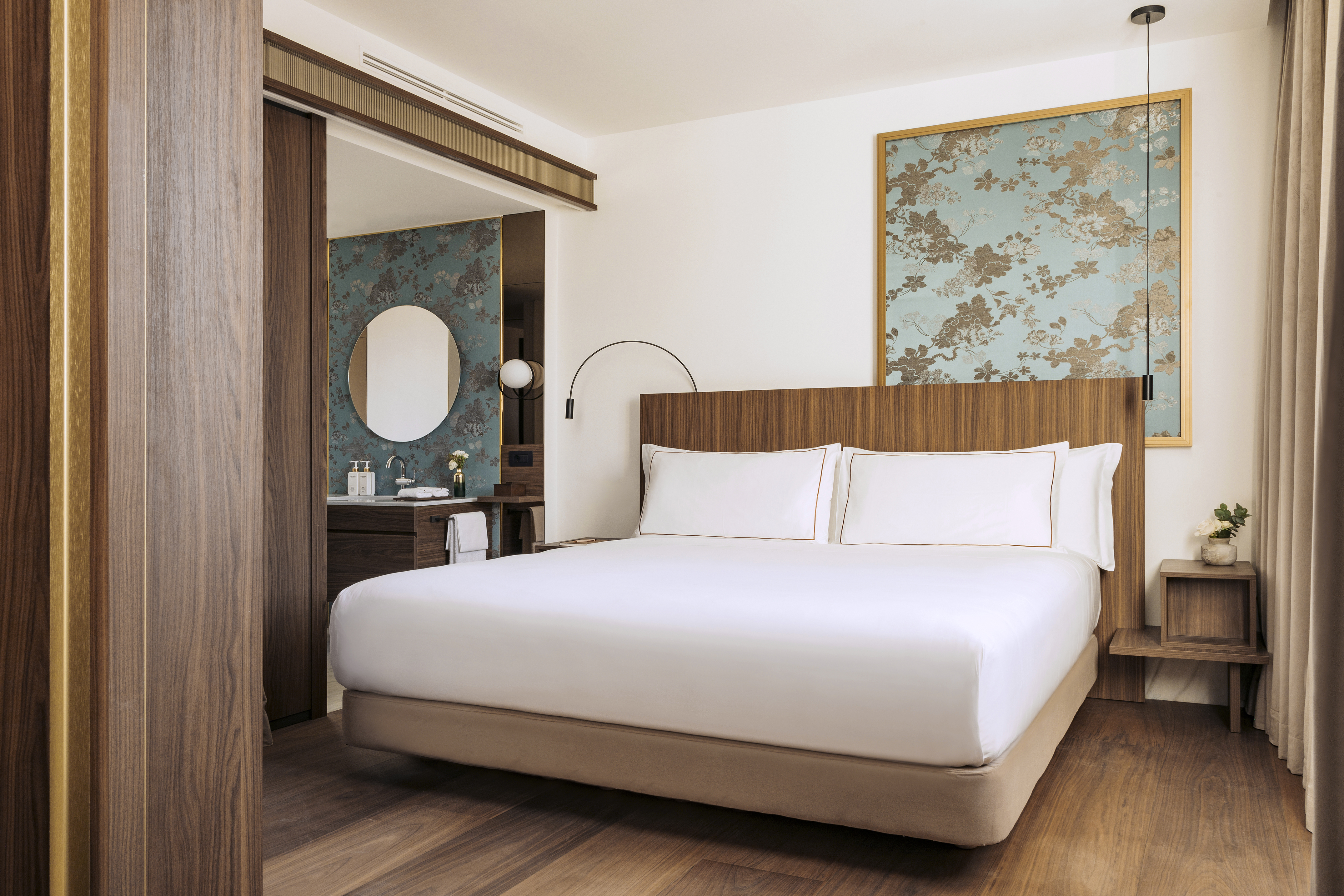 a bedroom with a bed and a mirror